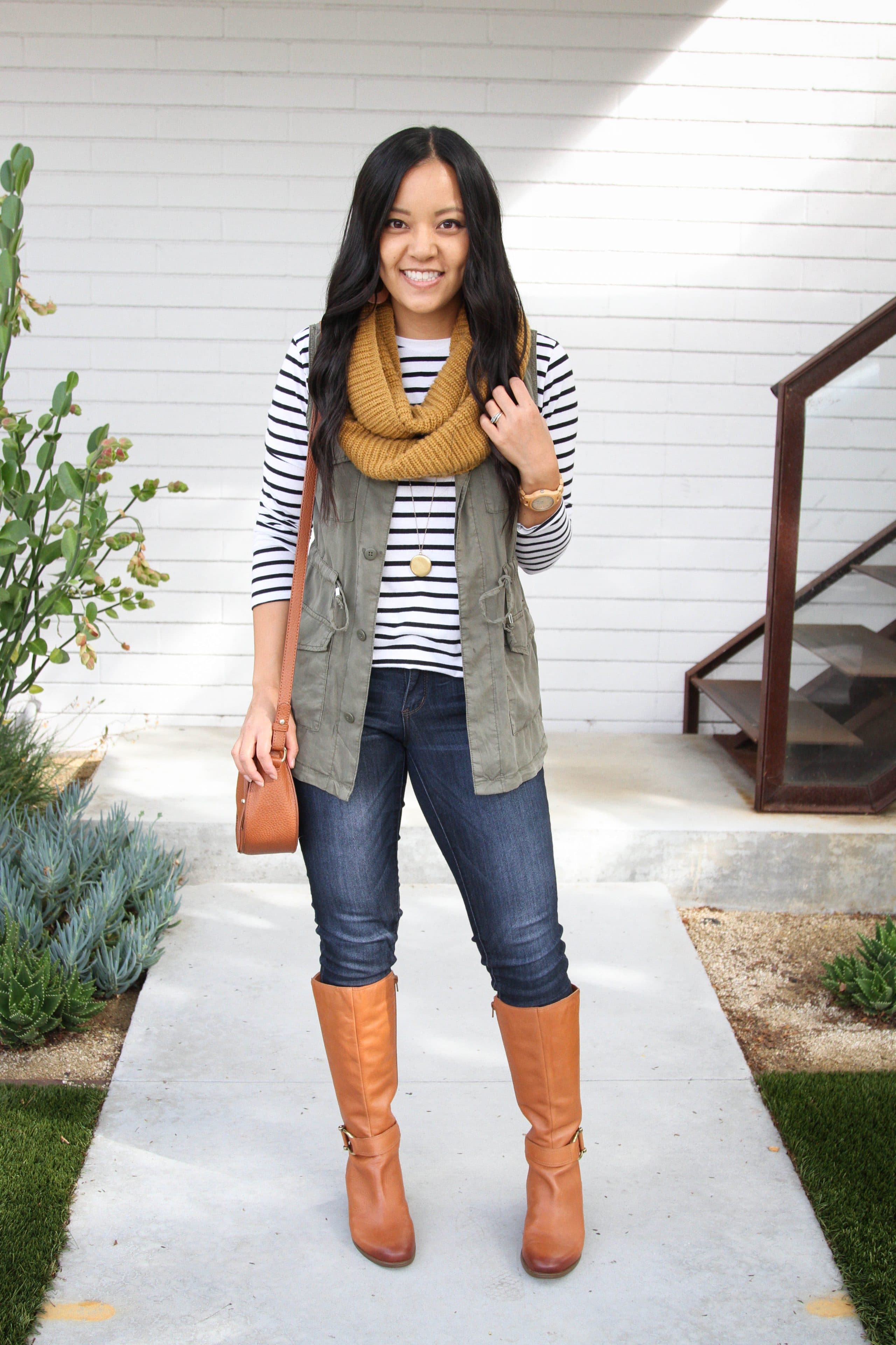 black and white striped top + olive utility vest + mustard scarf + skinny jeans + cognac boots + cognac tote